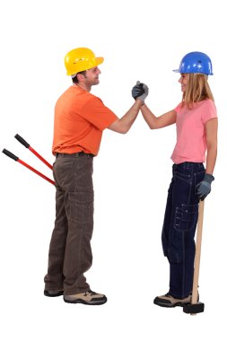 A couple of handyman shaking hands. clipart