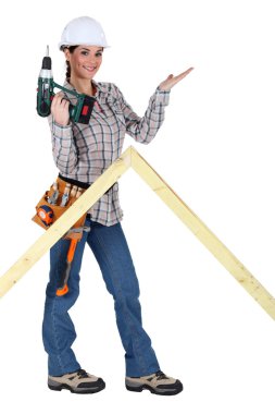 Woman with drill and wooden triangle clipart