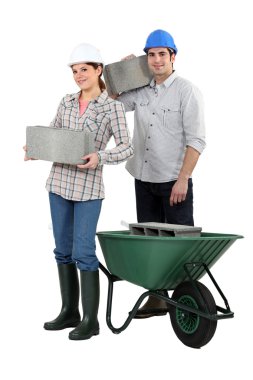 Construction workers carrying cinder blocks clipart