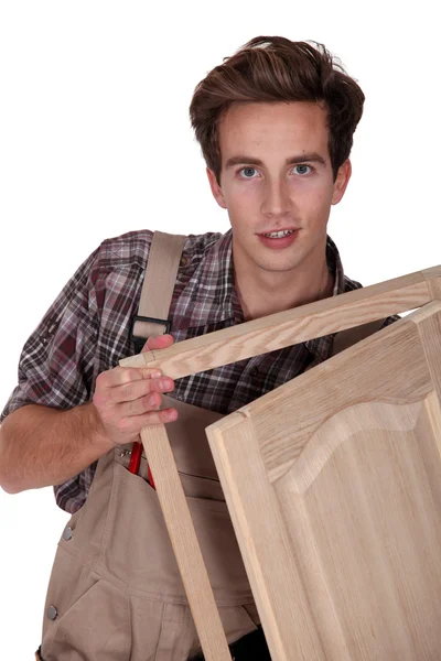 Jovem carpinteiro em fundo branco — Fotografia de Stock