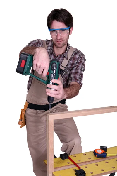 Carpenter screwing a frame together — Stock Photo, Image