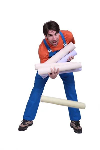 stock image Decorator dropping rolls of wallpaper