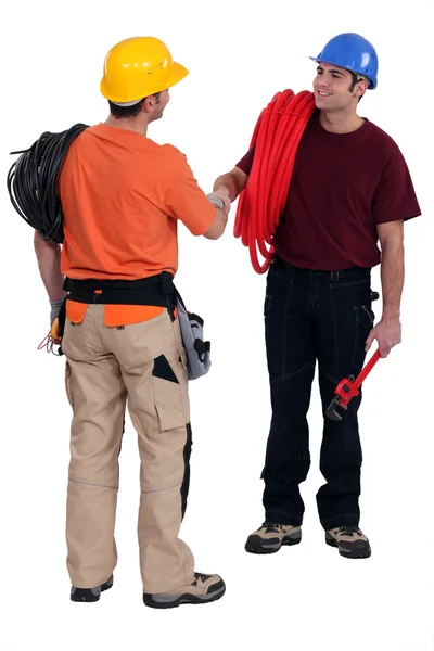 Tradesmen shaking hands in agreement — Stock Photo, Image