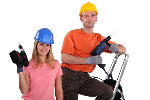 Man and woman with drills — Stock Photo, Image
