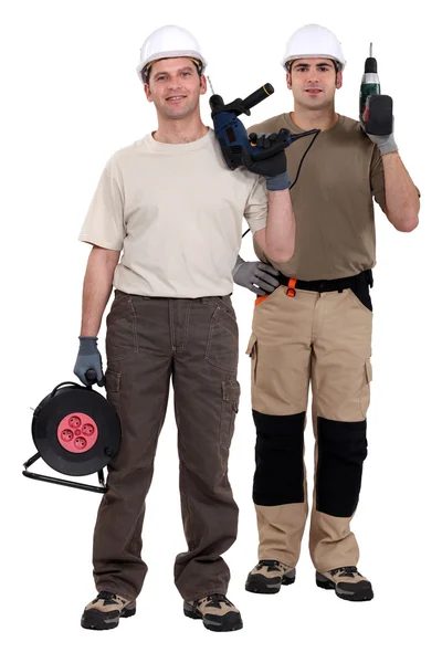 Dois homens segurando brocas elétricas — Fotografia de Stock
