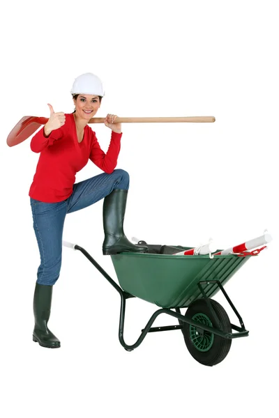 Woman with wheelbarrow giving thumbs-up — Stock Photo, Image