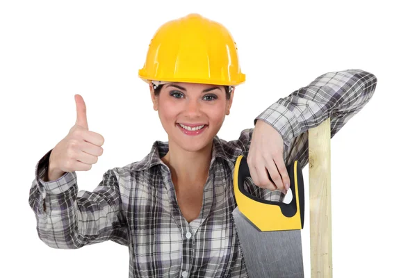 Uma mulher carpinteiro dando o polegar para cima . — Fotografia de Stock