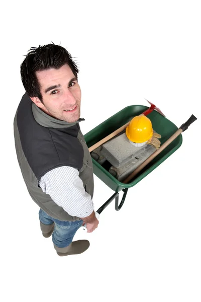 Construction worker with a wheelbarrow — Stock Photo, Image