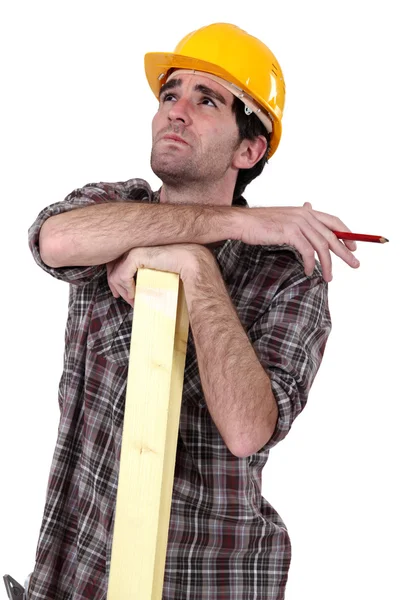 Woodworker thinking and calculating — Stock Photo, Image