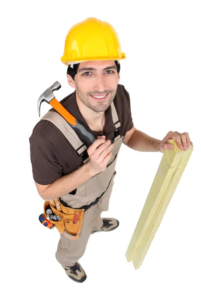 Carpenter with wood and a hammer — Stock Photo, Image