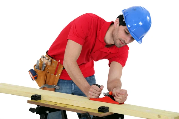 Man planning plank of wood — Stock Photo, Image