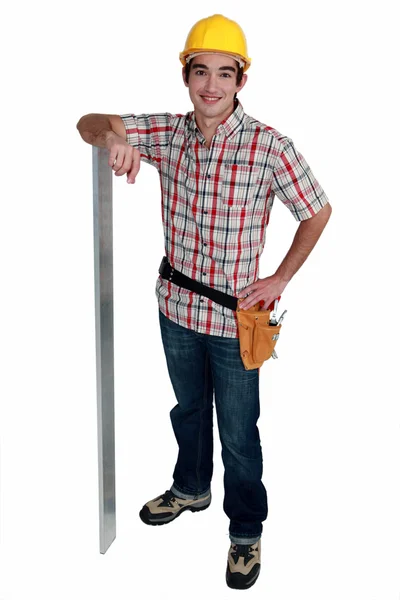 Construction worker with metal pole — Stock Photo, Image