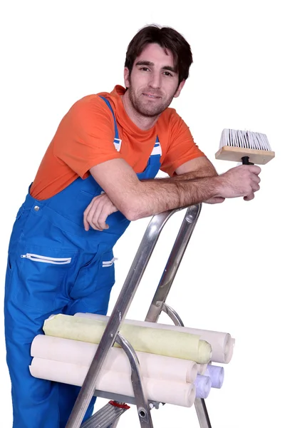 Man with rolls of wallpaper Stock Photo