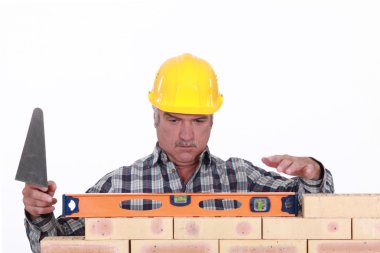 Mason leveling brick wall clipart