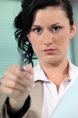 Close-up shot of a woman pointing her pen clipart