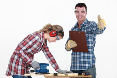 Couple working at a workbench clipart