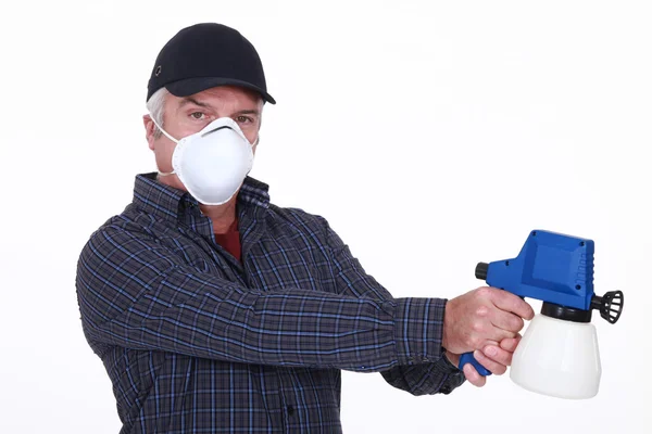 Man with a paint sprayer — Stock Photo, Image