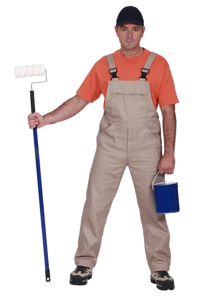 Decorator with a roller and pot of paint — Stock Photo, Image