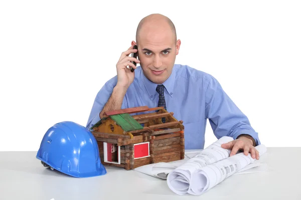 Real estate businessman talking on the phone in his office — Stock Photo, Image