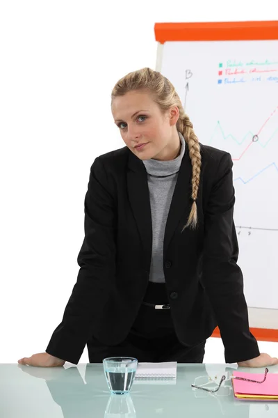 Woman in front of blackboard with graphics — Stock Photo, Image