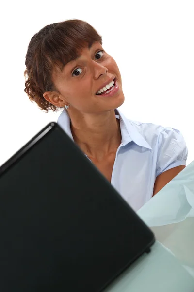 Mujer sonriendo a un ordenador portátil — Stockfoto
