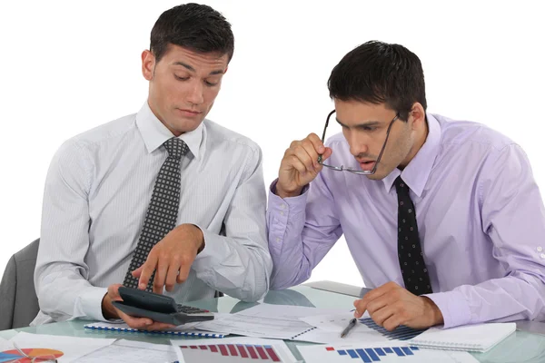 Businessmen scrutinizing financial results — Stock Photo, Image
