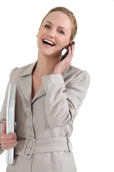 Businesswoman with laptop and cell-phone — Stock Photo, Image