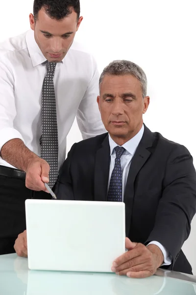 Executives looking computer project — Stock Photo, Image
