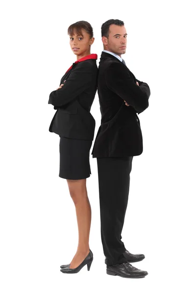 Businessman and businesswoman standing back-to-back — Stock Photo, Image