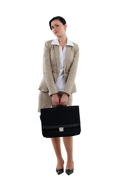 Coy businesswoman stood with briefcase — Stock Photo, Image