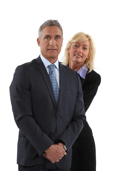 Blonde woman behind man in a suit Stock Image