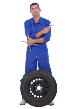 Mechanic with wheel clipart