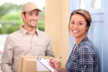 Delivery man and young woman clipart