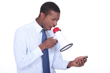Man shouting through a megaphone at a cellphone clipart