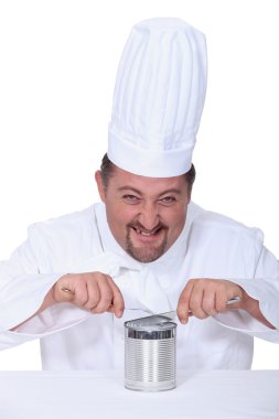 Chef cutting into tin can clipart