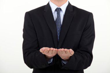 Businessman holding his hands straight palm-side up clipart