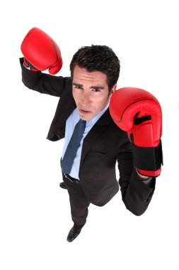 Successful businessman with boxing gloves clipart