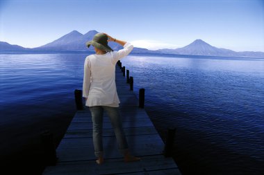 Woman stood on jetty clipart