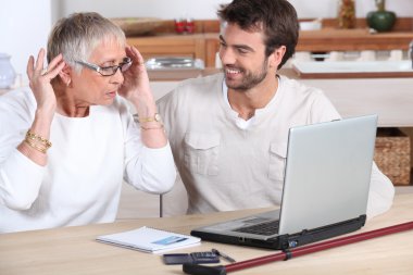 Elderly woman using computer clipart