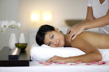 Woman receiving relaxing massage clipart