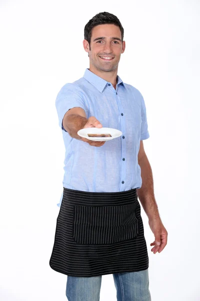 Man holding out saucer — Stock Photo, Image