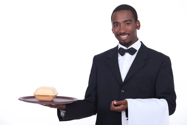 Butler serving a takeout burger — Stock Photo, Image