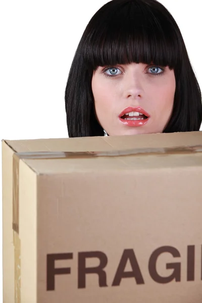 Young woman with moving cardboard — Stock Photo, Image