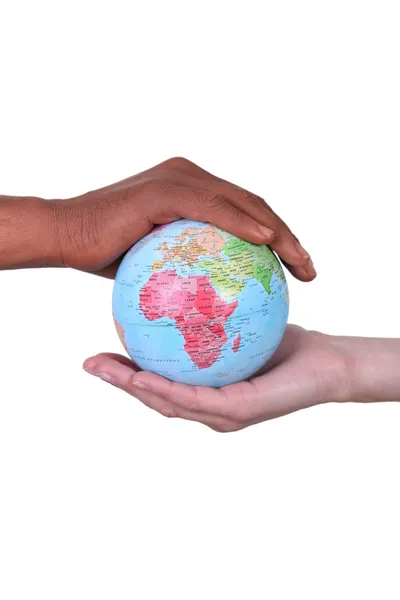 Black and white hands holding globe — Stock Photo, Image