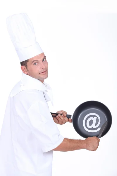 Chef with an @ sign on his frying pan — Stock Photo, Image