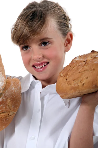Girl with loaves of bread — Stock Photo, Image