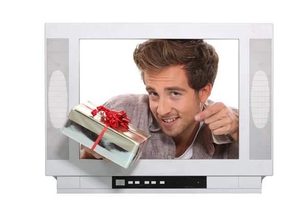 Man giving present in television — Stock Photo, Image