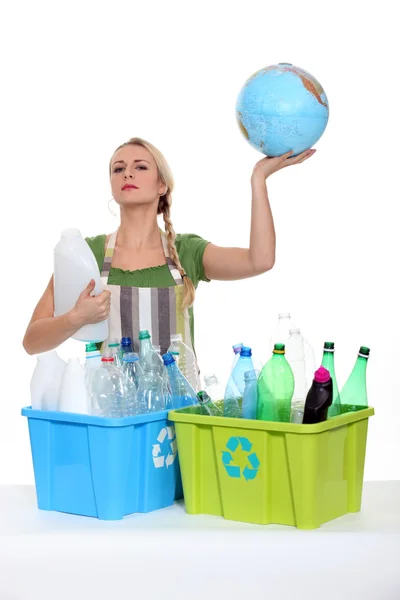 Woman recycling and holding planet earth in her hands — Stock Photo, Image