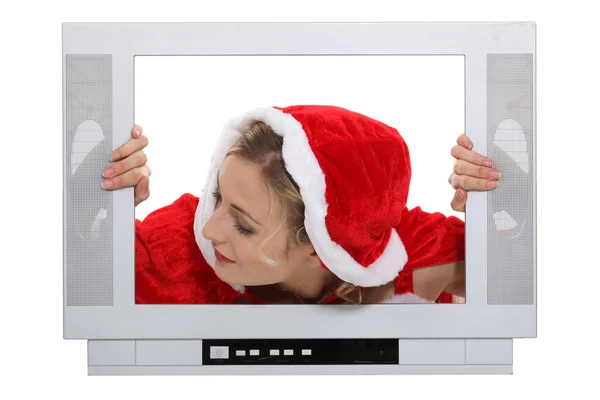 Woman with Christmas hat behind TV — Stock Photo, Image