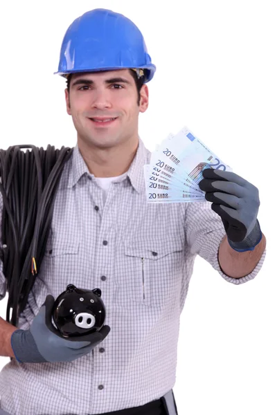Electrician with a piggy bank — Stock Photo, Image
